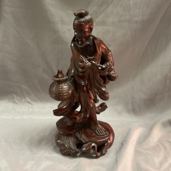 Detailed vintage Japanese wood carving of a fisherman.