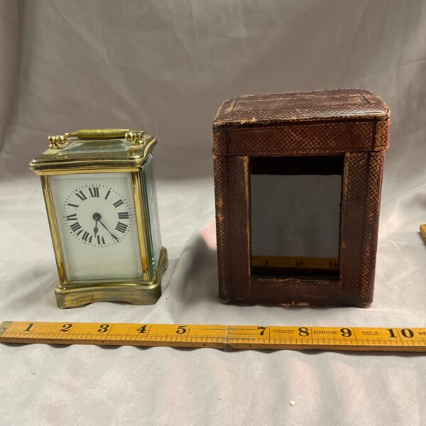 Antique brass carriage clock with original travel case, Victorian timepiece.