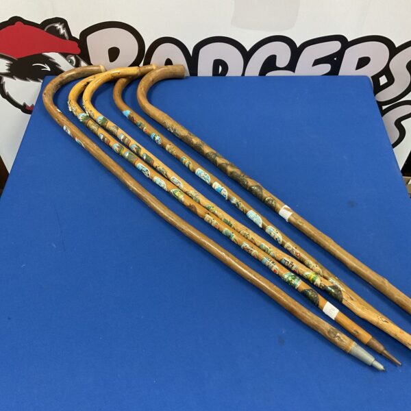Vintage walking sticks with travel plaques, antique collectible canes.
