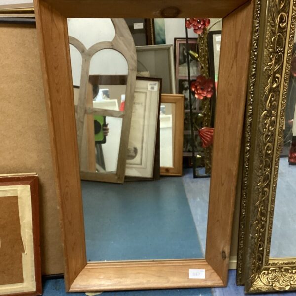 Vintage wooden framed mirror with a simple rectangular design.