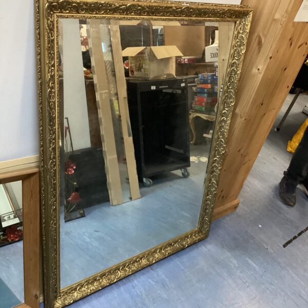 Large antique gilt framed mirror with bevelled edge.
