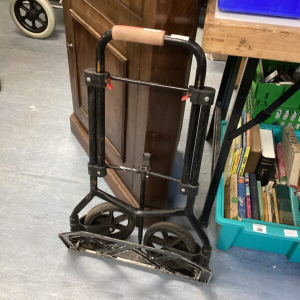 Vintage folding sack barrow with a single wheel.