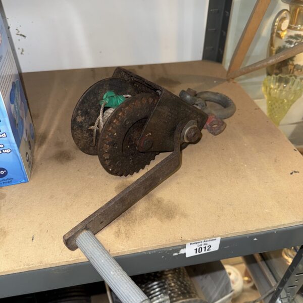Vintage trailer winch with D shackle for towing.
