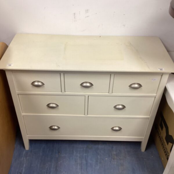 White three over two dresser for bedroom storage.