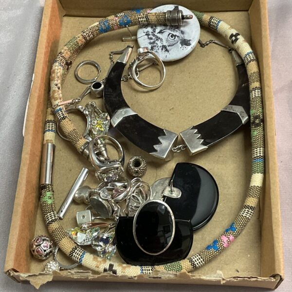 Tray of mixed silver jewellery, including necklaces and charms.