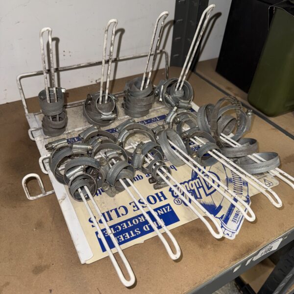 Assorted jubilee clips on a rack, useful for hose repair.