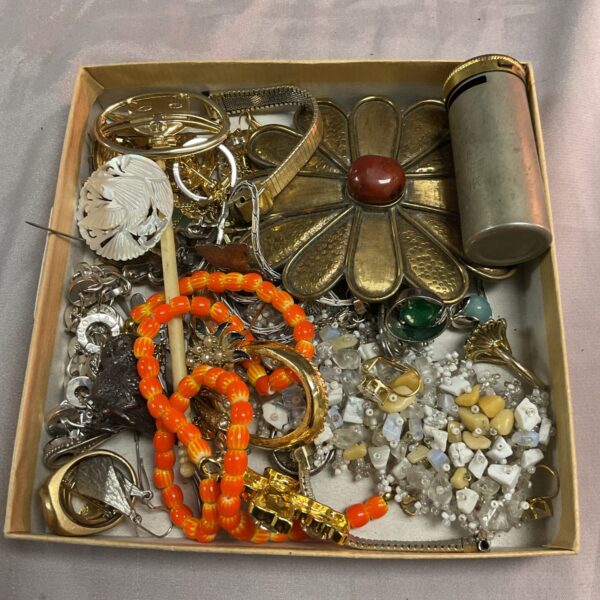 Assorted vintage costume jewellery tray with brooches and beads.