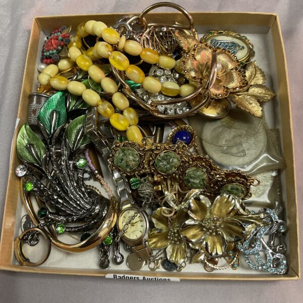Assorted vintage costume jewellery tray with brooches and necklaces.