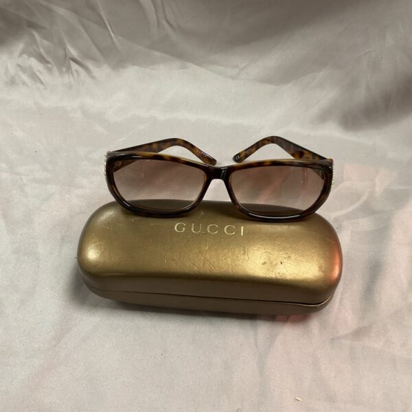 Front view of vintage Gucci tortoiseshell sunglasses with case.