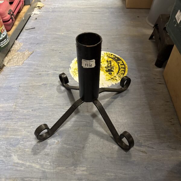 Vintage wrought iron Christmas tree stand with four legs.