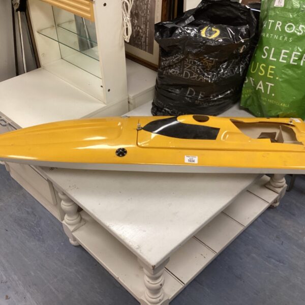 Yellow vintage remote controlled speedboat for restoration project.