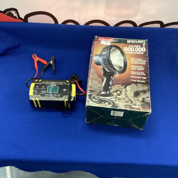 Coleman spotlight and battery charger with halogen bulb.