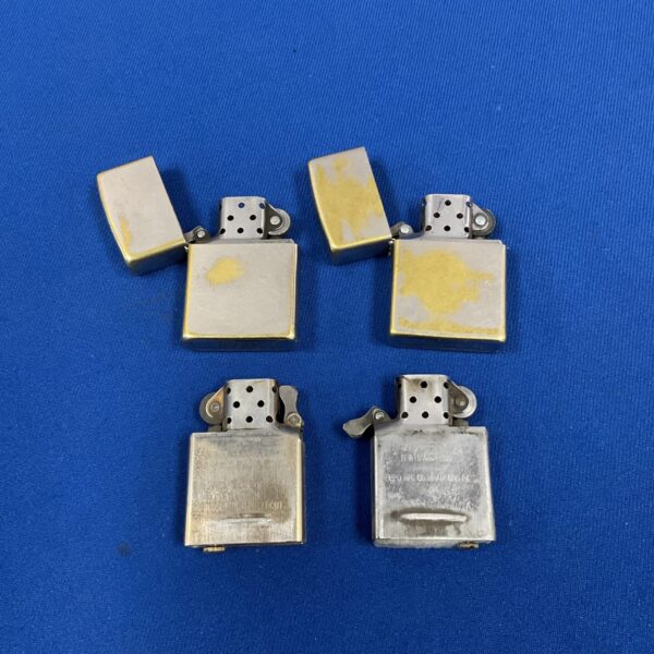 Pair of vintage Zippo lighters, collectible metal design.