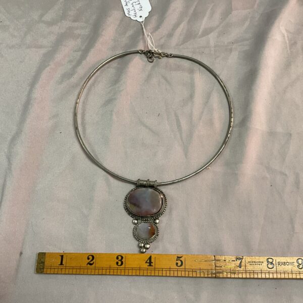 Close-up of a moss agate choker necklace with natural stone details.