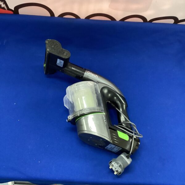 Gtech vacuum cleaner with charger for cordless cleaning.