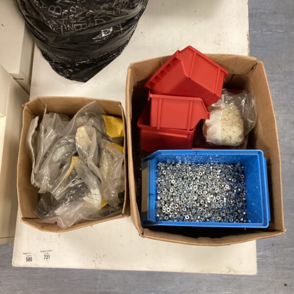 Assorted hardware boxes with nuts, bolts, and washers.