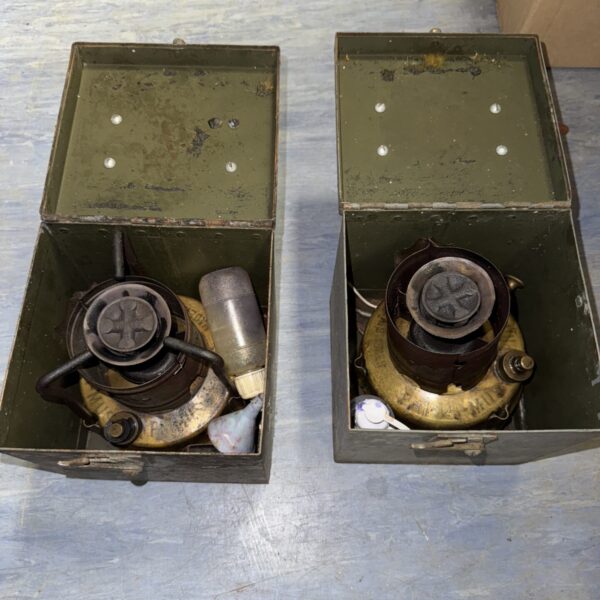 Two vintage Primus stoves inside a green enamel carrying case.