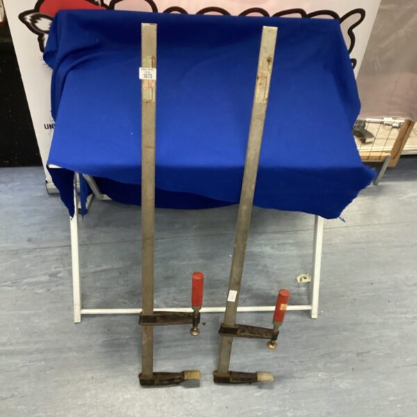 Vintage sash clamps with wooden handles for woodworking projects.