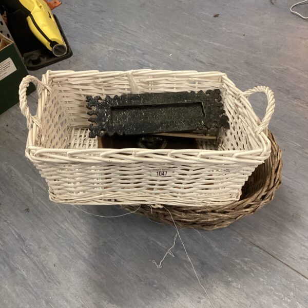 Vintage wicker baskets with letter slips and a door knocker.