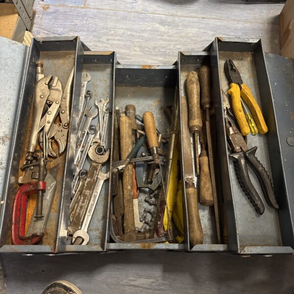 Vintage cantilever toolbox filled with antique tools for collectors.