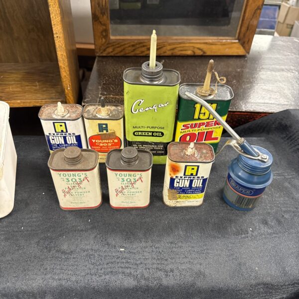 Vintage collection of metal oil cans, including gun oil.