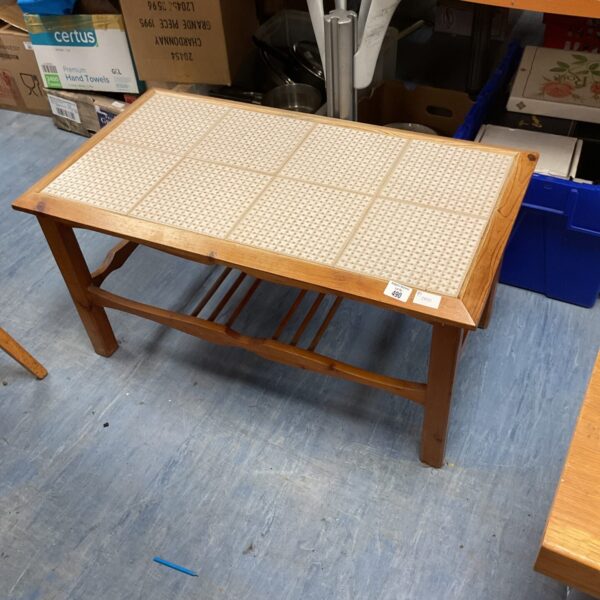 Vintage tile top coffee table with wooden frame and retro design.