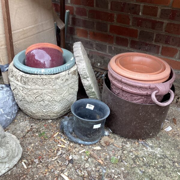 A collection of vintage and terracotta garden planters.