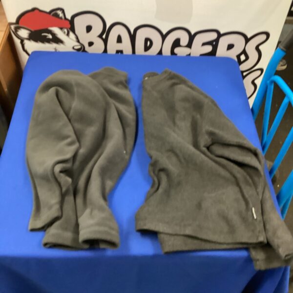 Two Rohan 2XL fleece sweaters displayed on a table.