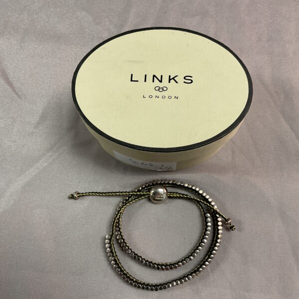 Elegant Links of London silver bracelet on a neutral background.