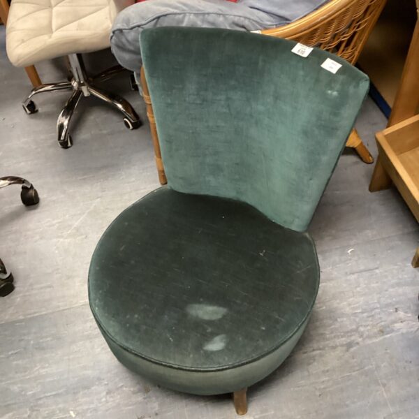 Vintage turquoise bedroom chair with curved back.