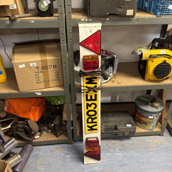 Used trailer lightboard with rear lights for towing vehicles.