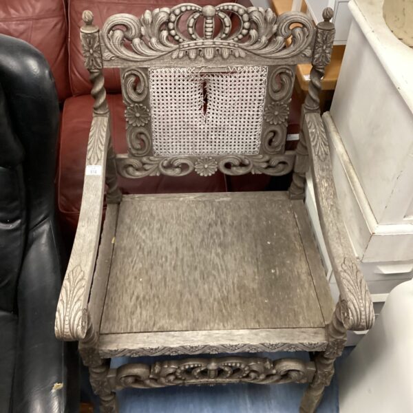 Ornate antique carved chair with floral details.