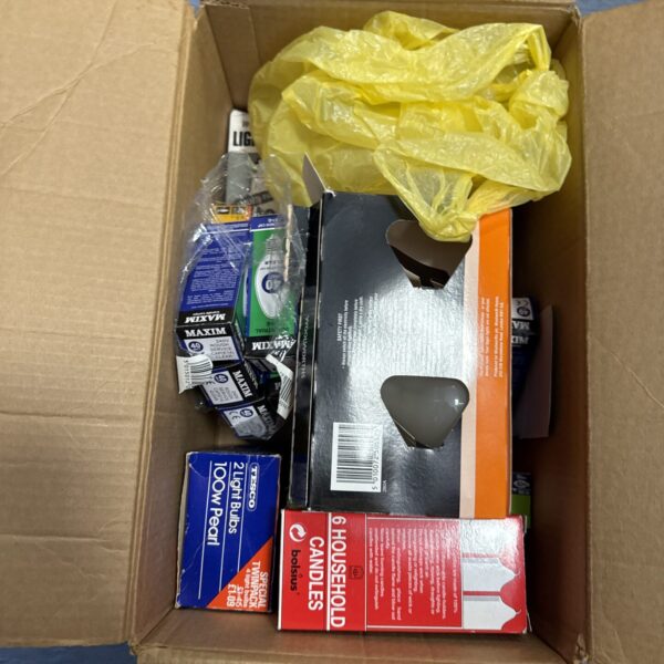 Box of assorted light bulbs for household lighting.