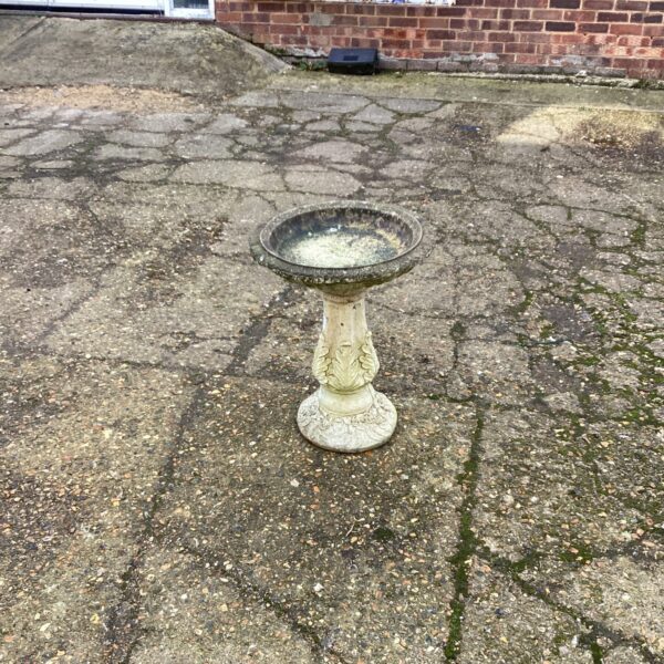 Tiered stone garden bird bath for attracting birds outdoors.