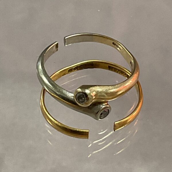 Close-up of two 9ct gold diamond rings with a diamond setting.
