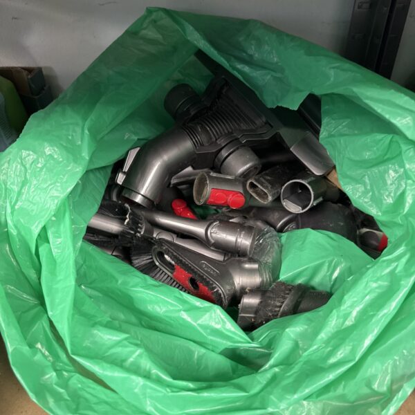 Lot of assorted Dyson vacuum cleaner accessories and attachments.
