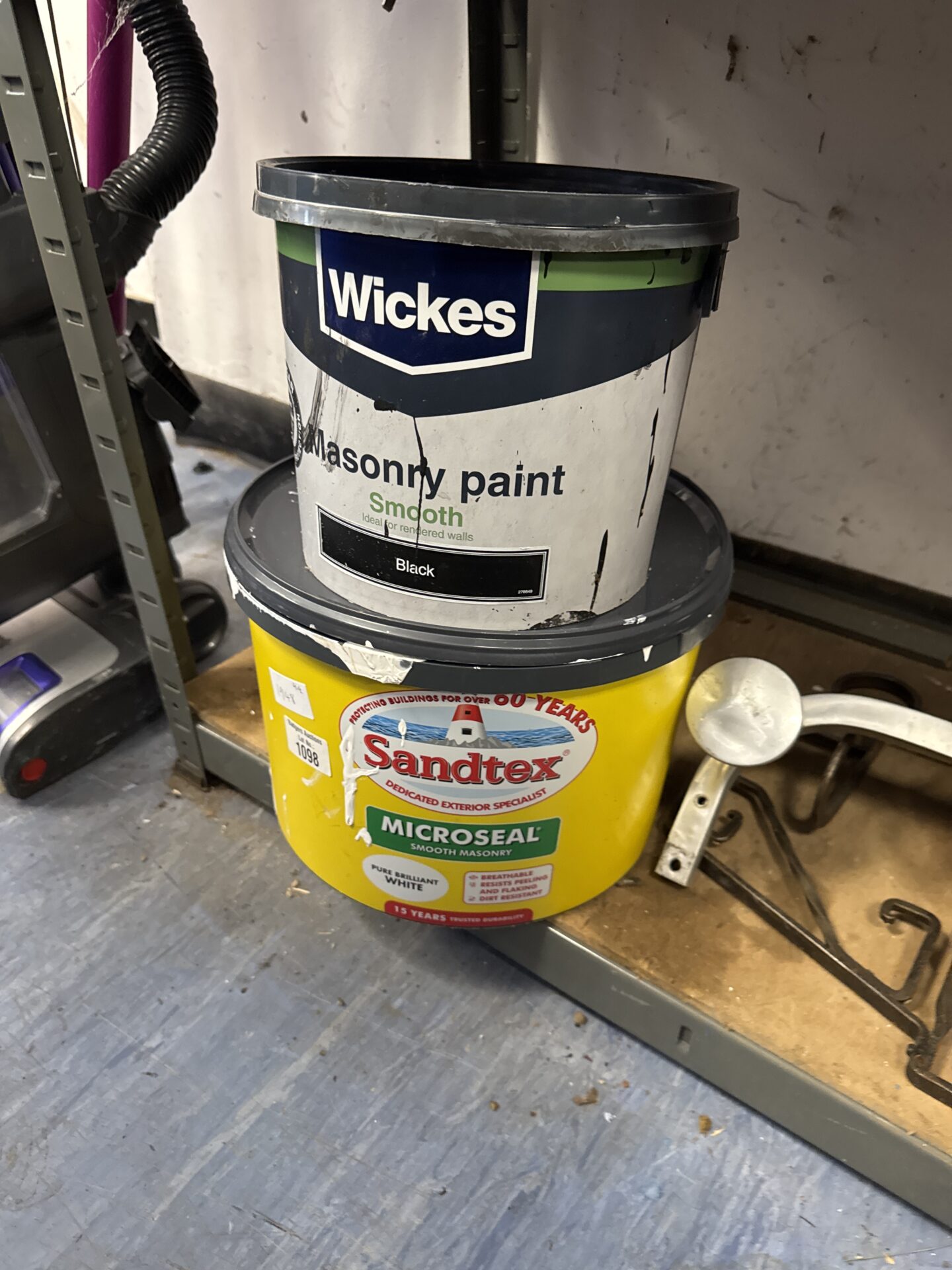 1098 Wickes black masonry paint (feels 3/4 full) with tub of sandtex brilliant white (feels 1/2 full)