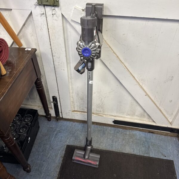 Dyson V6 cordless vacuum cleaner with charger, offered for repair.