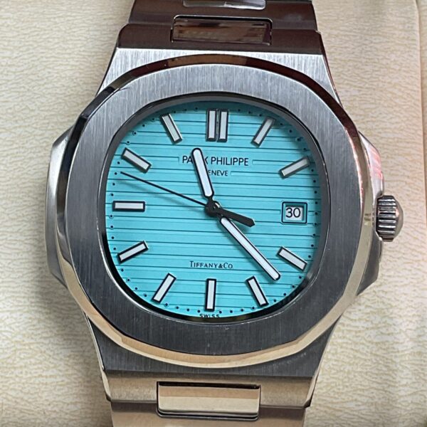 Patek Philippe Tiffany & Co watch with turquoise dial and stainless steel bracelet.
