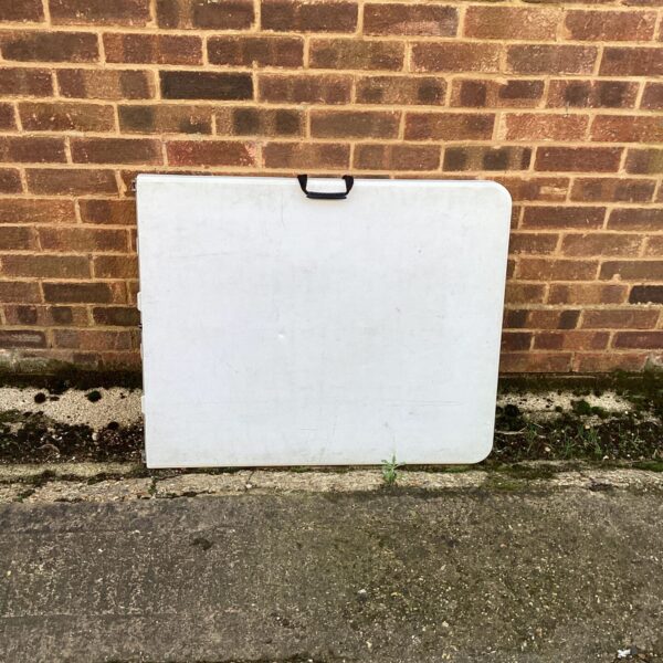 White six-foot folding table, ideal for events and camping.