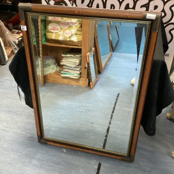 Antique wooden framed mirror with a classic rectangular shape.