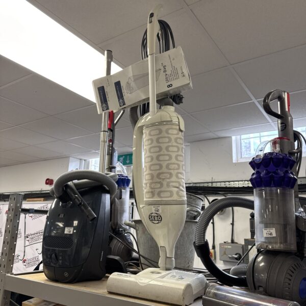 Front view of a white and blue Sebo Felix vacuum cleaner.