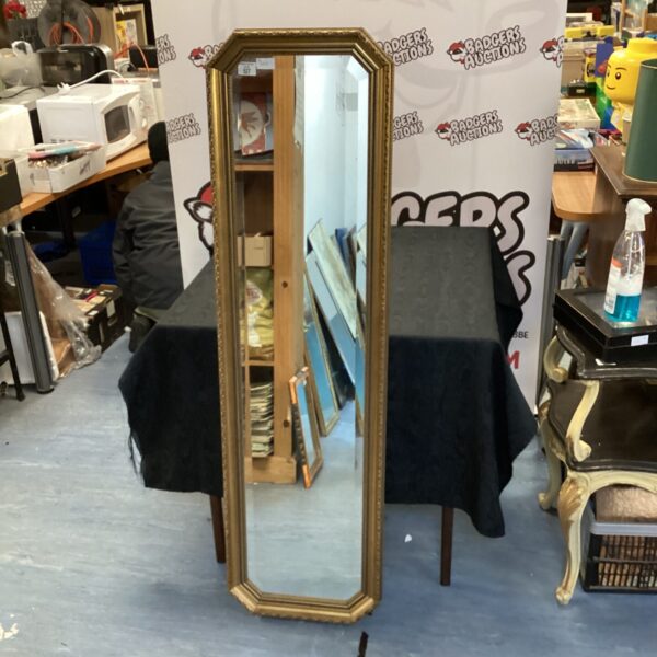 Ornate gilt framed bevelled mirror for wall decoration.