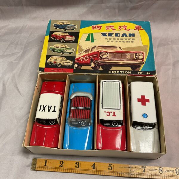 Lot of four vintage Chinese tin friction cars, colourful and collectible.