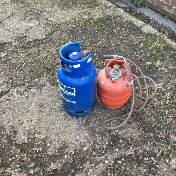 Vintage gas bottles and blowtorch lot for garden or DIY use.