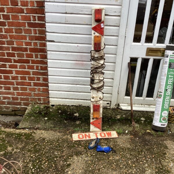 Trailer lighting board with ‘On Tow’ sign and ratchet straps.