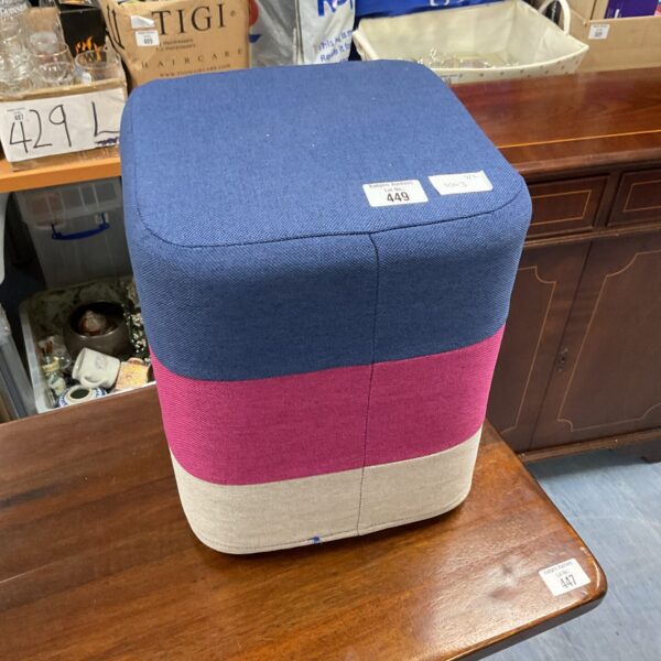 Colourful fabric footstool for home decor and comfortable seating.