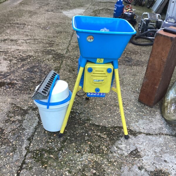 Blue and yellow Golia grain mill for grinding grains.