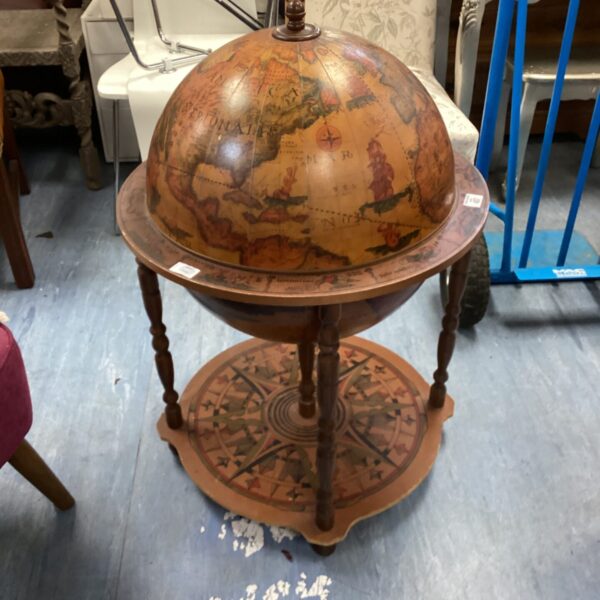 Vintage globe bar cabinet with detailed map design.