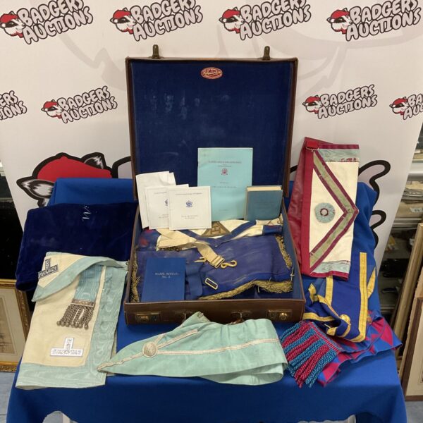Leather case containing a collection of masonic aprons and sashes.